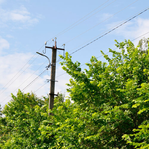 Power electric pole with line wire on colored background close up. Photography consisting of power electric pole with line wire under sky. Line wire in power electric pole for residential buildings.